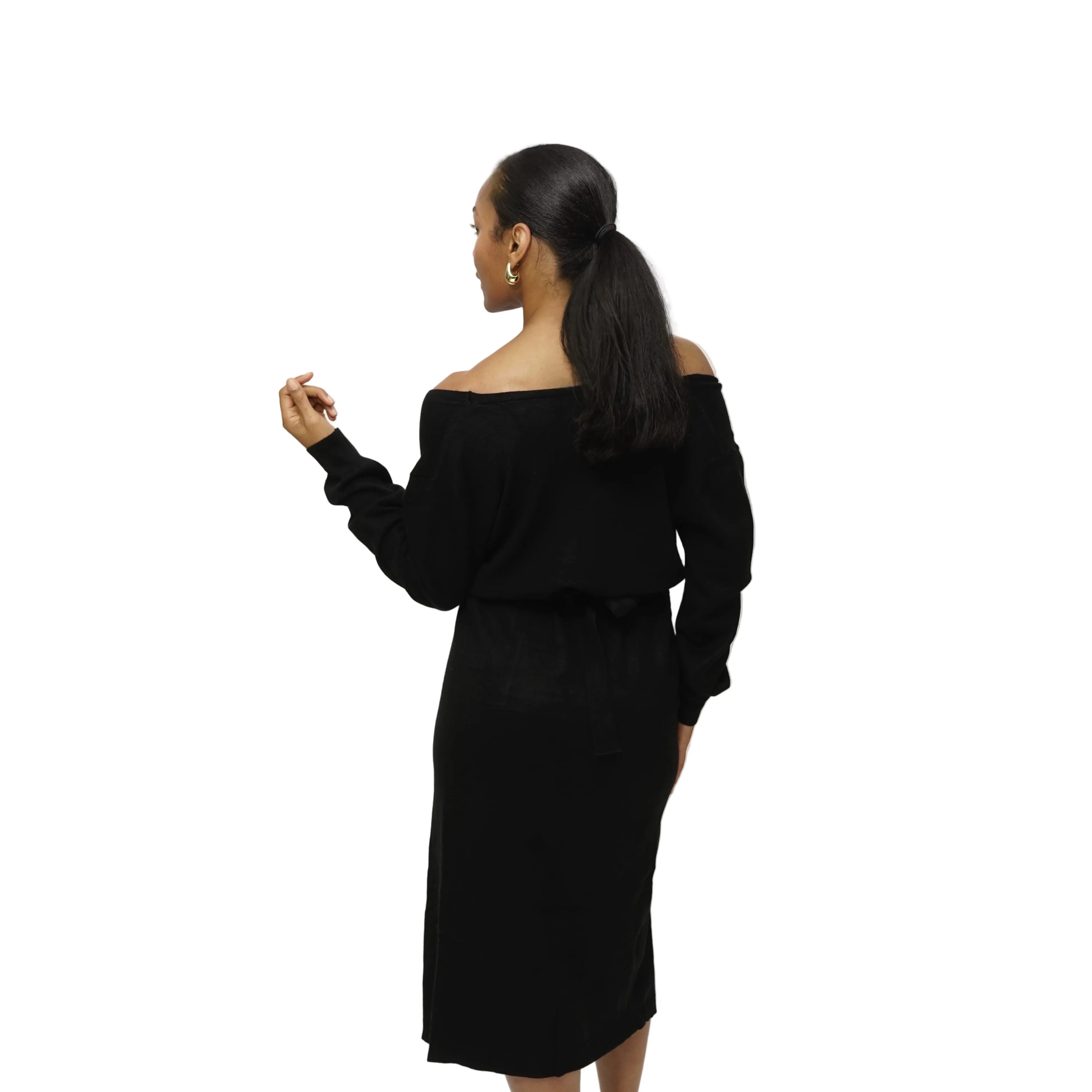 Woman wearing a black off-shoulder dress against a white background